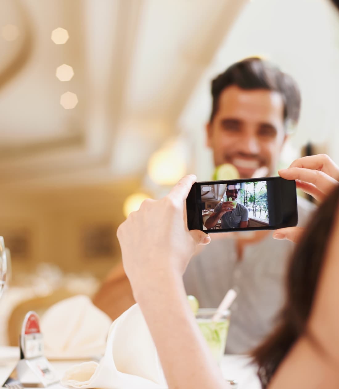 A guest taking a candid photo across a dinner table